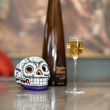 Aperitif glass next to a skull