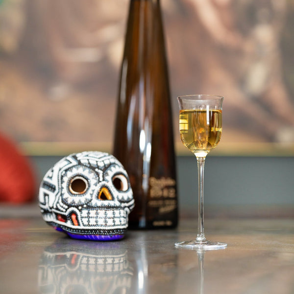 Aperitif glass next to a skull