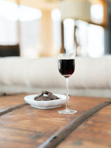 Aperitif glass next to a bowl of chocolates